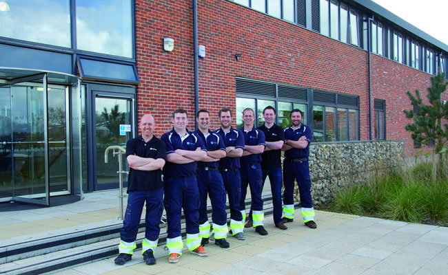 From L to R, Bryan Glasser, Sam Vincent, Andy Hack, John Boyes, Roy Wilkes, Richard Nunn and Mark Rockliff outside the Sheringham Shoal purpose built O&ampM base Wind Farm Place