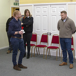 Ross McMillan (far right) addresses guests of 'About with Friends' at the Grand Switch On